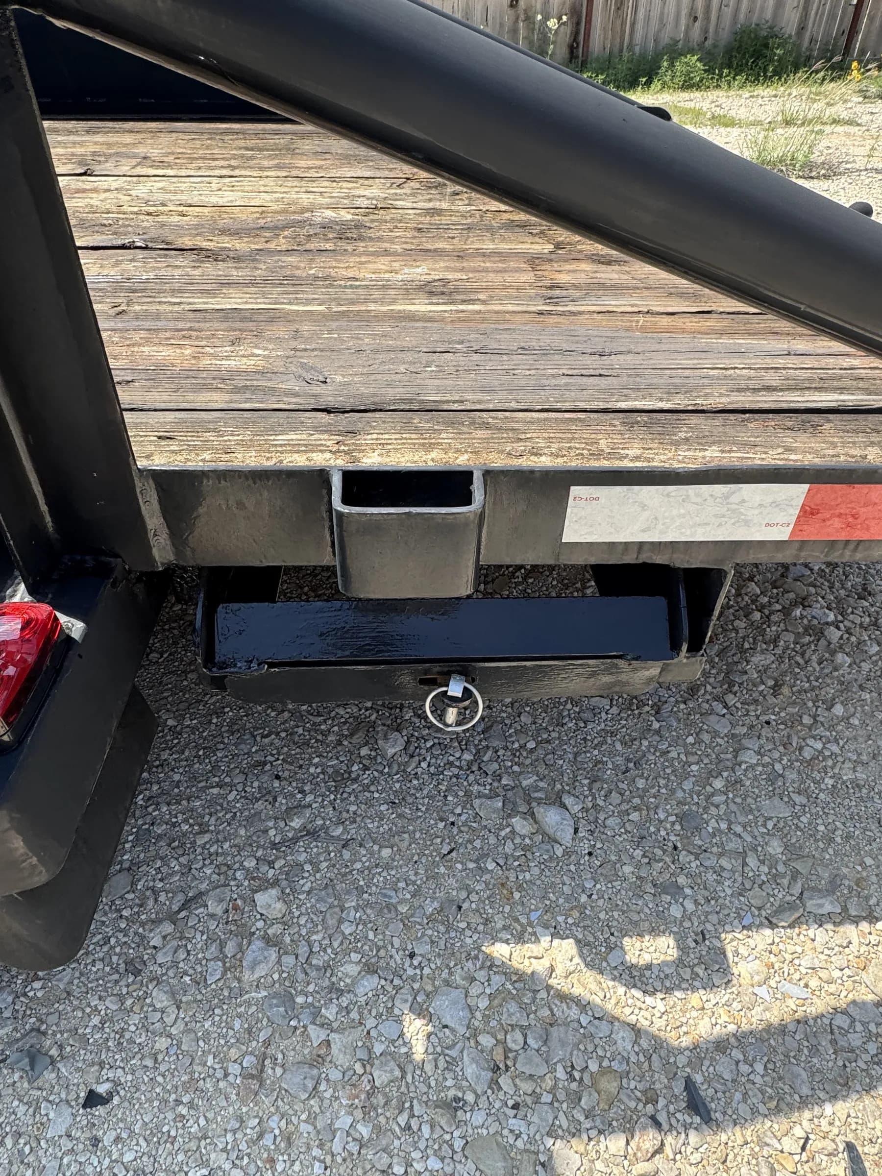Rear hitch and weathered wood deck close-up on the RedLine 16-foot trailer