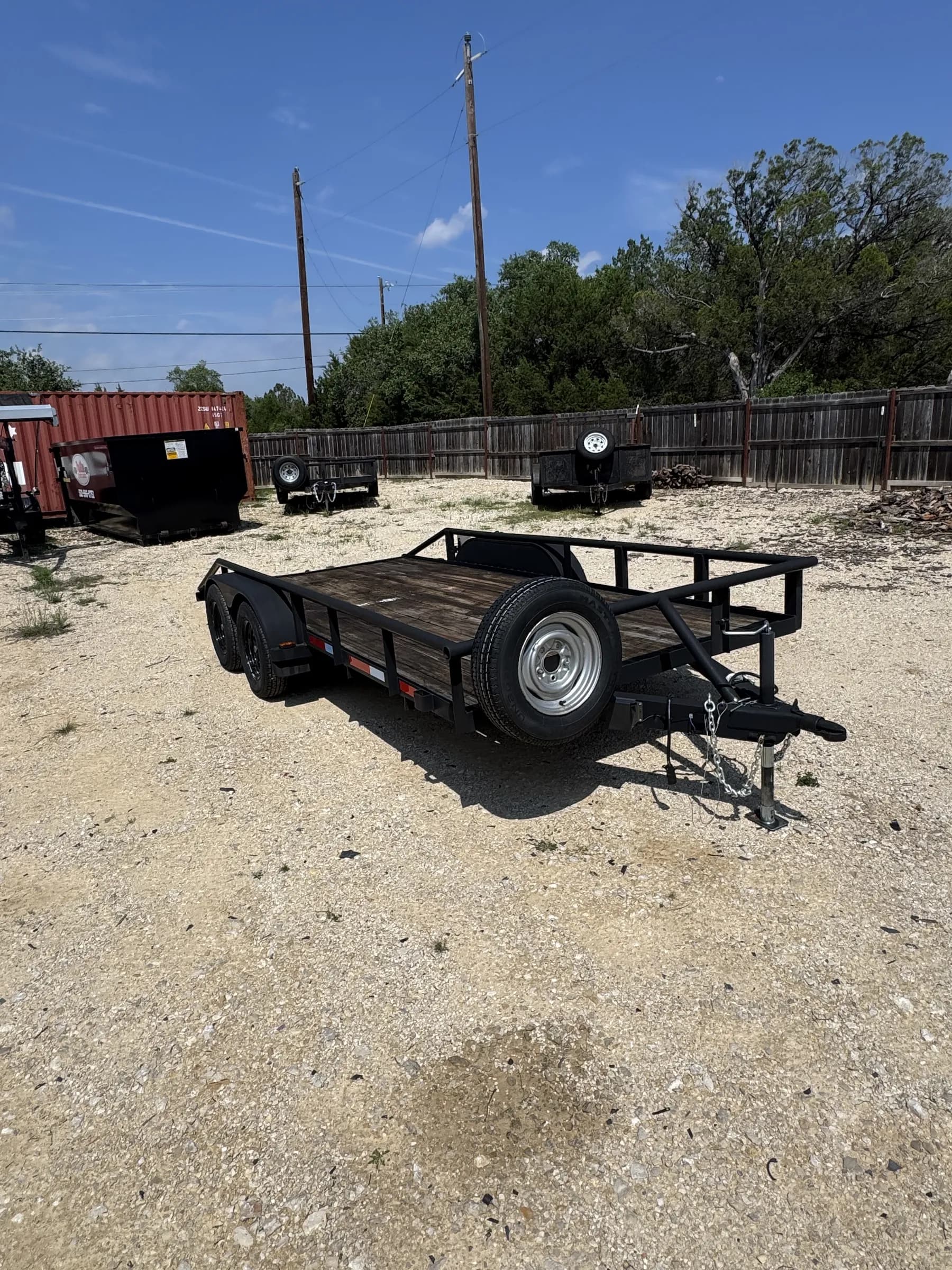 16-foot flatbed utility trailer with dual axles on the RedLine rental lot