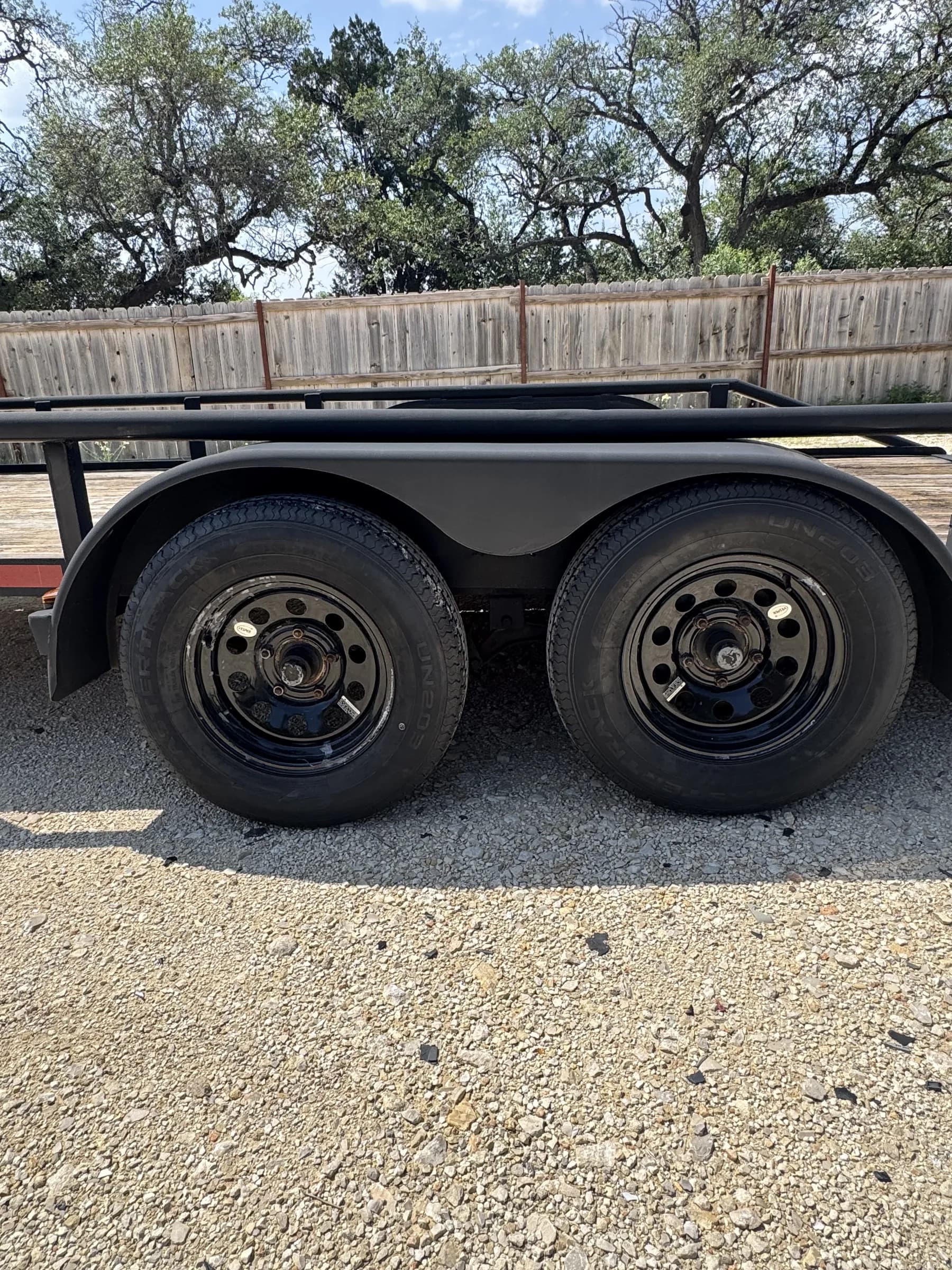 Dual axle steel wheels close-up on the RedLine 16-foot utility trailer