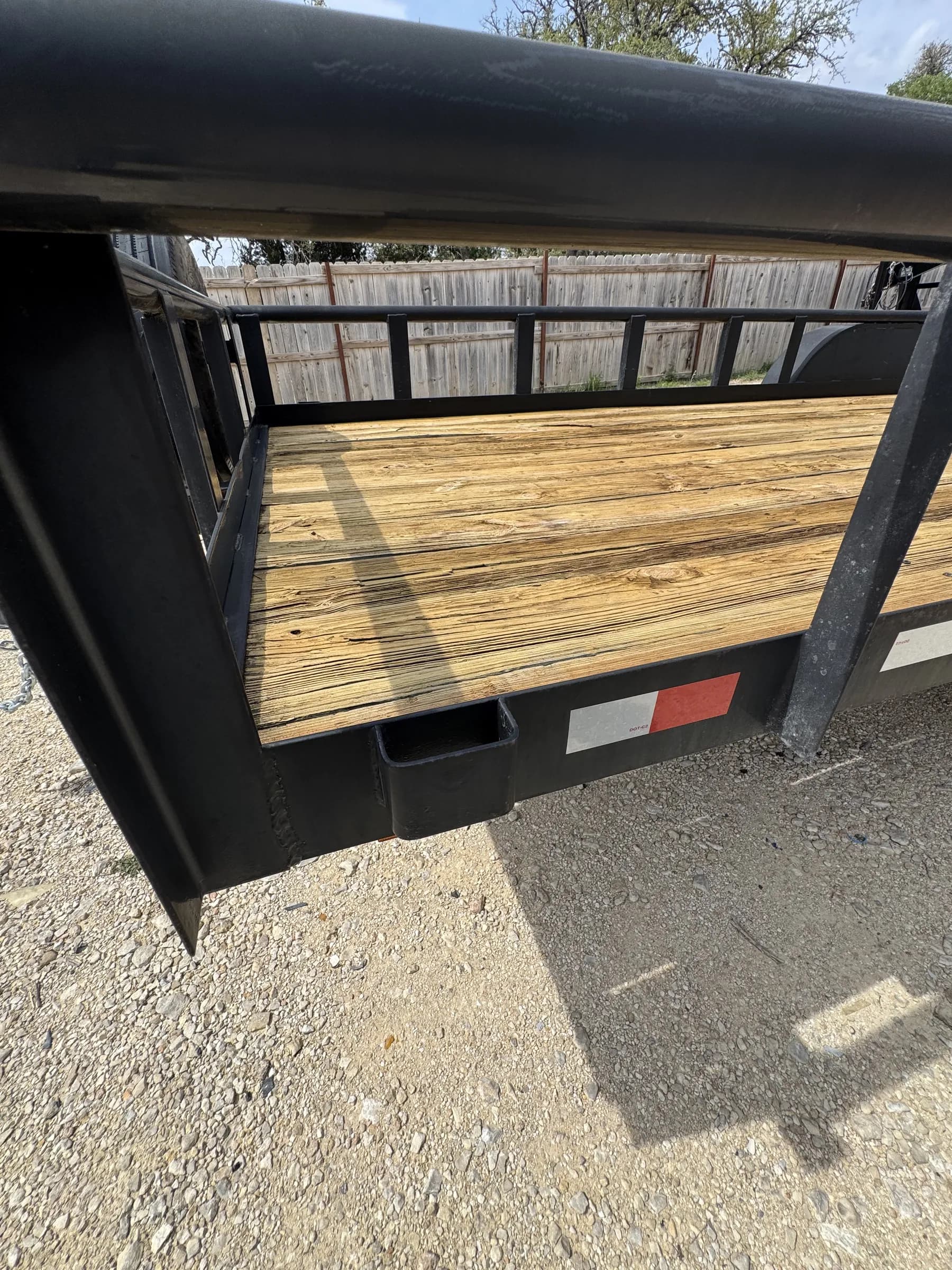 20-foot flatbed trailer wooden deck and steel frame close-up at RedLine rental lot