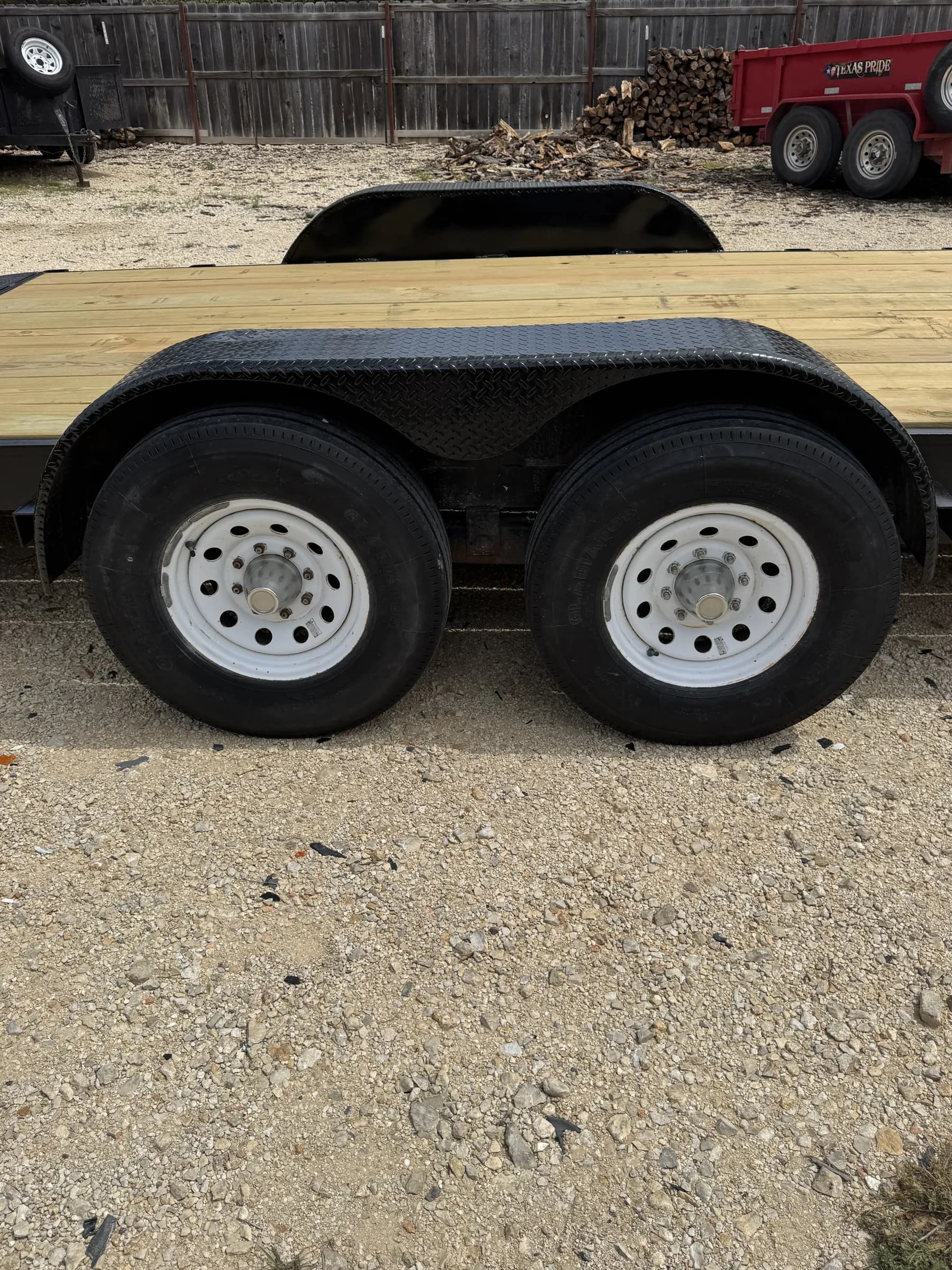 Dual axle wheels and diamond plate fenders close-up on the RedLine 24-foot gooseneck