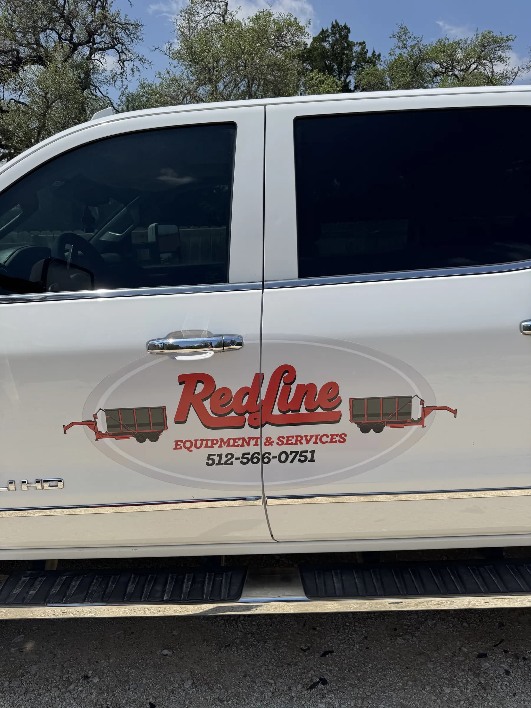 RedLine Equipment & Services white pickup truck with the RedLine logo on the equipment lot
