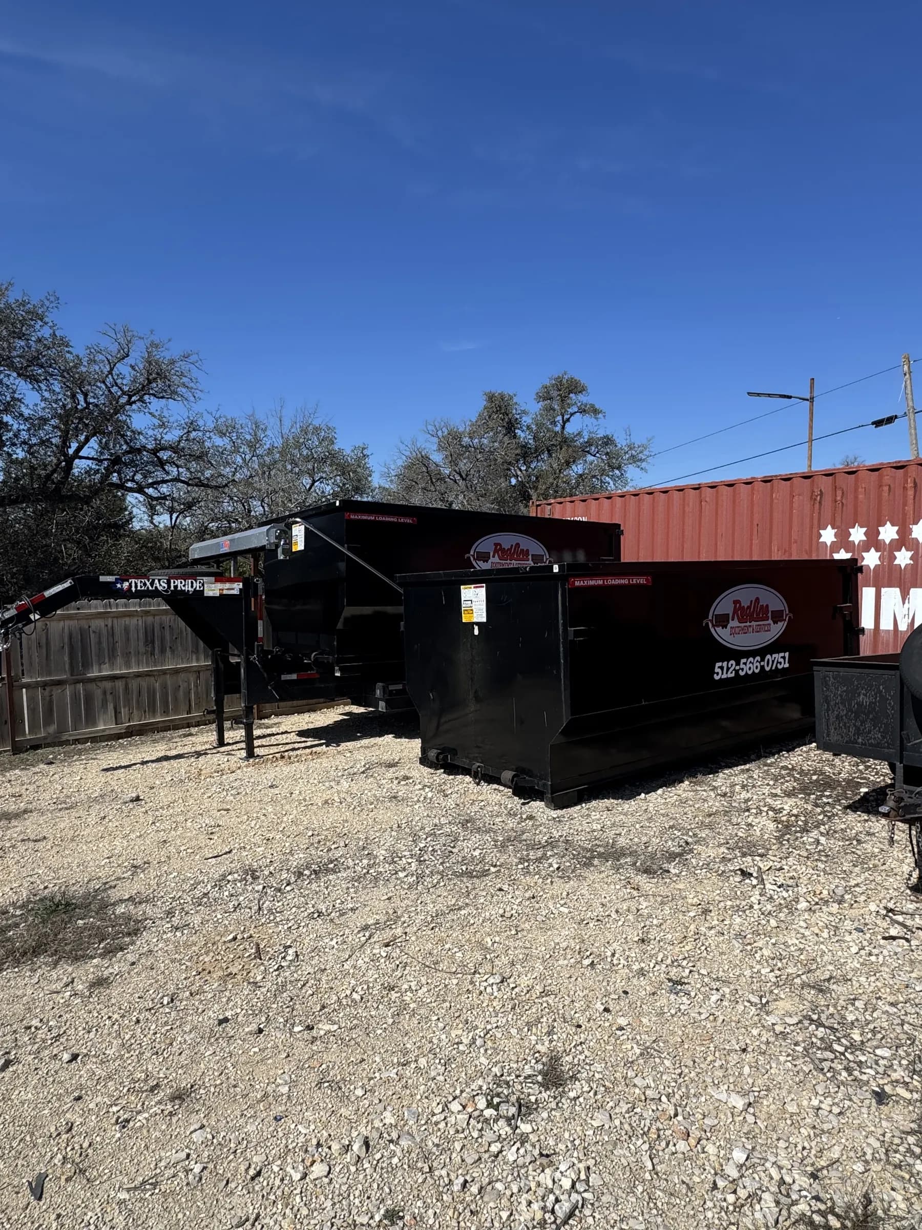 RedLine Waste Services dumpsters on the gravel lot with Texas Pride branding