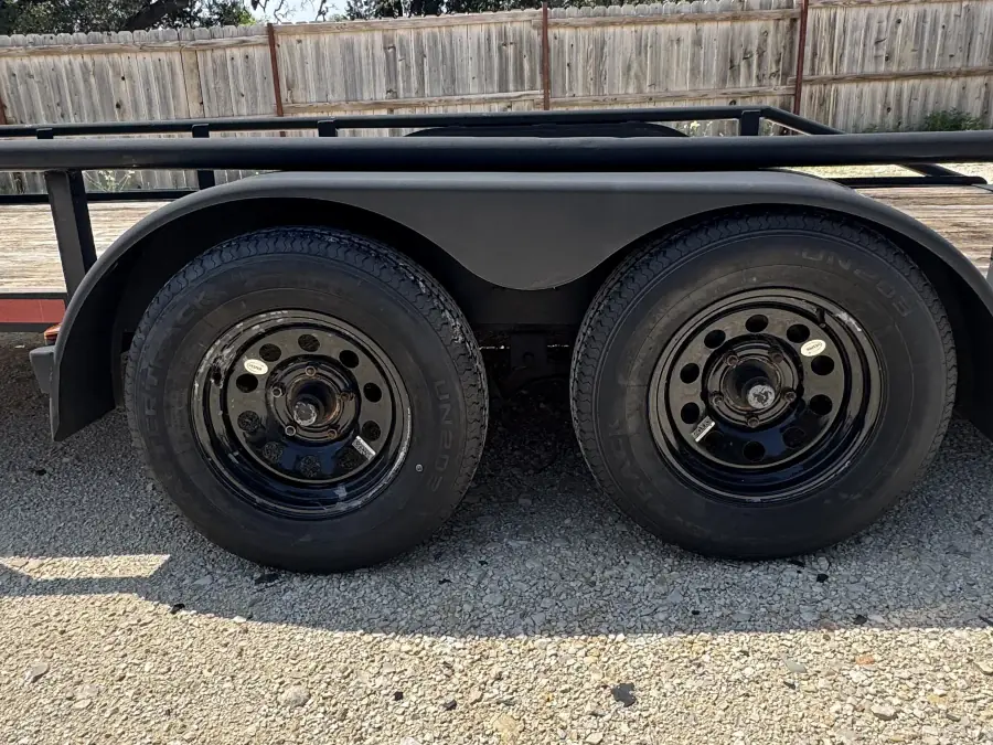 Dual axle steel wheels close-up on the RedLine 16-foot utility trailer