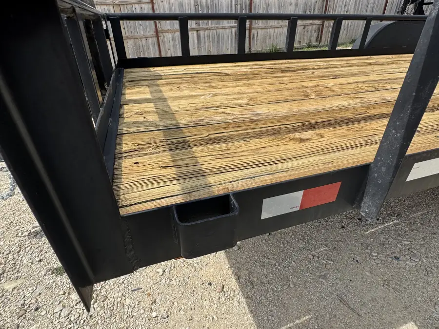 20-foot flatbed trailer wooden deck and steel frame close-up at RedLine rental lot