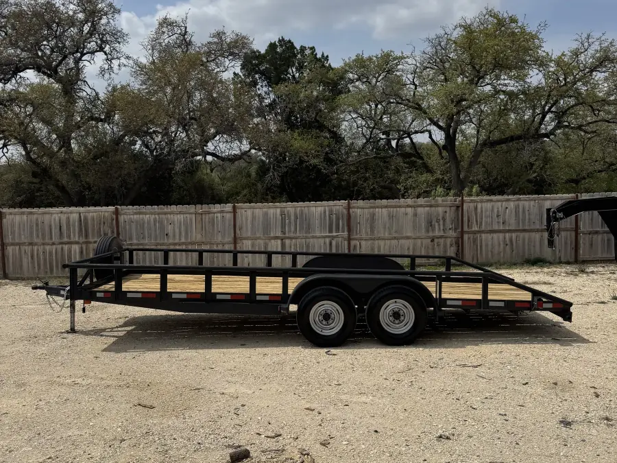 20-foot black utility trailer with wood deck on the RedLine rental lot, Texas Hill Country
