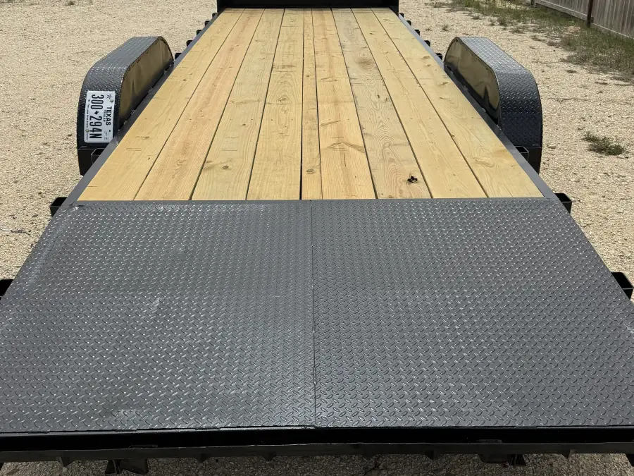 24-foot gooseneck trailer with wood deck and diamond plate steel ramps at the RedLine rental lot