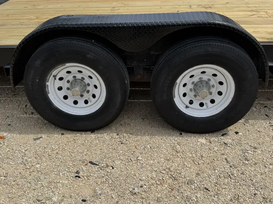 Dual axle wheels and diamond plate fenders close-up on the RedLine 24-foot gooseneck
